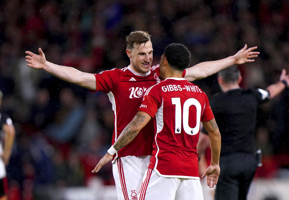 Nottingham Forest's Chris Wood, left, celebrates with team-mate Morgan Gibbs-White after scoring their side's second goal during the English Premier League soccer match between Nottingham Forest and Fulham at the City Ground, in Nottingham, England, Tuesday, April 2, 2024. (Bradley Collyer/PA via AP)