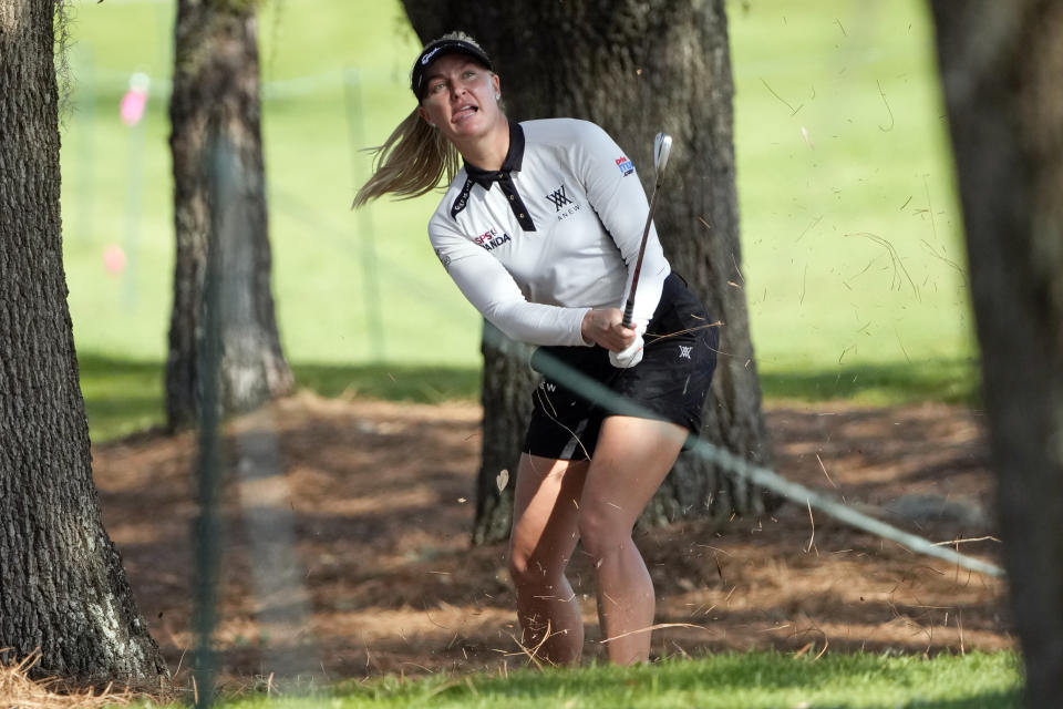 Charley Hull, of England, watches her shot from between some trees off the eighth fairway during the first round of the LPGA Hilton Grand Vacations Tournament of Champions Thursday, Jan. 19, 2023, in Orlando, Fla. (AP Photo/John Raoux)