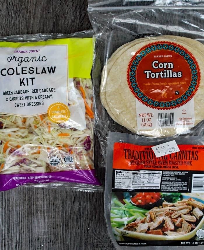 Carnitas, slaw, and tortillas in packaging.