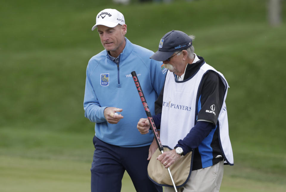 FILE - Jim Furyk, left, and his caddie Mike Cowan talk on the second hole during the final round of The Players Championship golf tournament in Ponte Vedra Beach, Fla., in this Sunday, March 17, 2019, file photo. Furyk and Cowan have been together for 22 years. (AP Photo/Lynne Sladky, File)