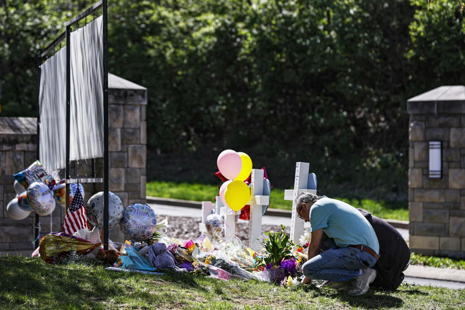 People pray at a memorial at the entrance to the Covenant School in Nashville, Tenn. (Wade Payne / AP)