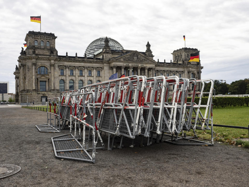 Barriers are located at the Reichstag building in Berlin, Germany, Friday, Aug. 28, 2020. After the ban on a large demonstration against corona measures, the courts are now deciding. Police in Berlin have requested thousands of reinforcements from other parts of Germany to cope with planned protests at the weekend by people opposed to coronavirus restrictions. (Paul Zinken/dpa via AP)