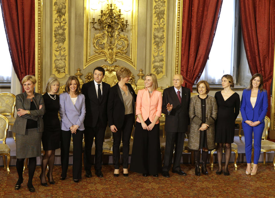 Italian President Giorgio Napolitano, fourth from right, poses for a family photo with Premier Matteo Renzi, fourth from left, and the women ministers of his Cabinet, at the end of a swearing in ceremony of the new government at the Quirinale Presidential Palace, in Rome, Saturday, Feb. 22, 2014. From left, Economic Development Minister Federica Guidi, Education Minister Stefania Giannini, Health Minister Beatrice Lorenzin, Renzi, Defense Minister Robeta Pinetti, Foreign Minister Federica Mogherini, President Napolitano, Regional Affairs Minister Maria Carmela Lanzetta, Semplification and Public Administration Minister Marianna Madia, and Relations with Parliament Minister Maria Elena Boschi. (AP Photo/Andrew Medichini)