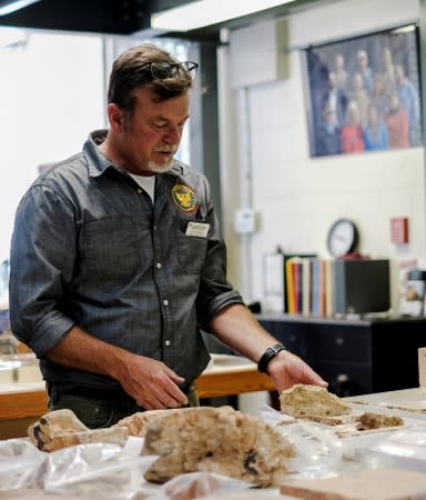 Archeologist Given inspects artifacts at Jamestown Rediscovery Center in Jamestown, Virginia