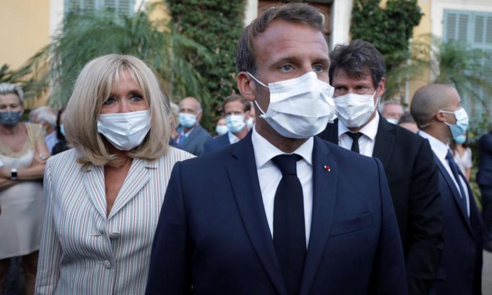 President Macron and wife Brigitte wearing masks at a public engagement. Mask-wearing has become a subject of controversy in Marseille.