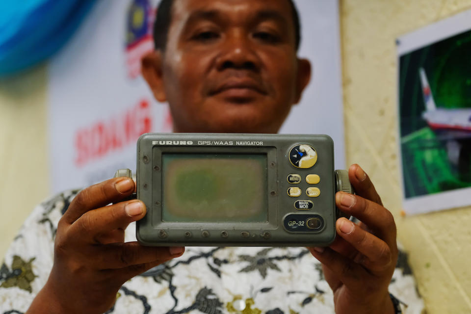 Mr Khusmin shows his GPS navigator to reporters (Picture: Getty)