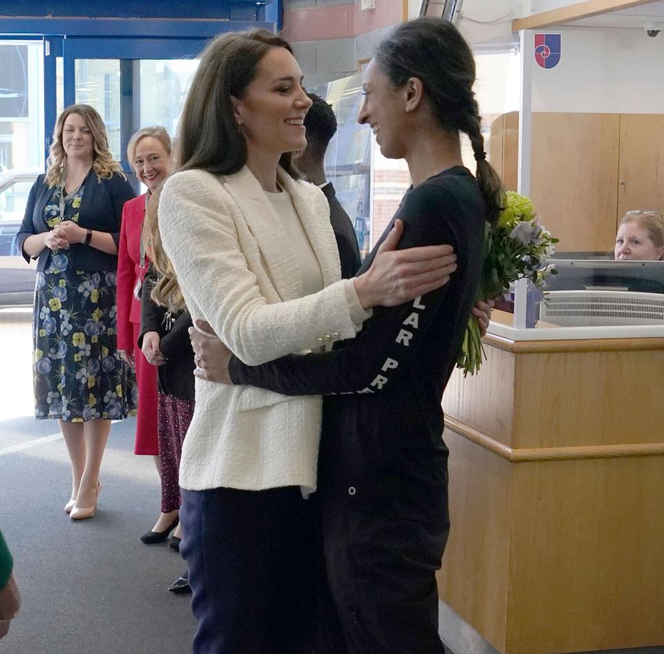 Kate, Princess of Wales, left, greets Captain Preet Chandi, during a visit to Landau Forte College, in Derby, England, to celebrate Captain Chandi's return from her solo expedition across Antarctica