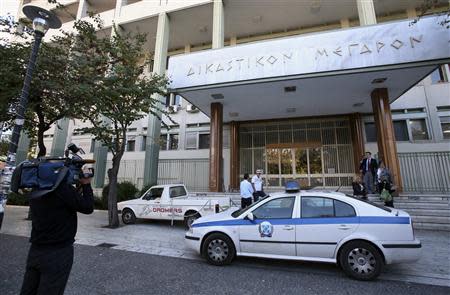 Members of the media wait outside a courthouse in the town of Larisa, some 350 km (217 miles) north of Athens, October 21, 2013. REUTERS/Leonidas Tsekas/ICON