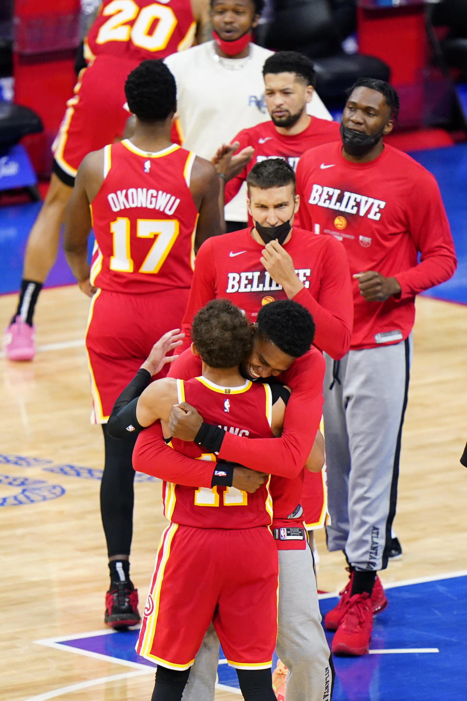 Atlanta Hawks' Trae Young, left, celebrates with teammates after the Hawks won Game 5 in a second-round NBA basketball playoff series against the Philadelphia 76ers, Wednesday, June 16, 2021, in Philadelphia. (AP Photo/Matt Slocum)