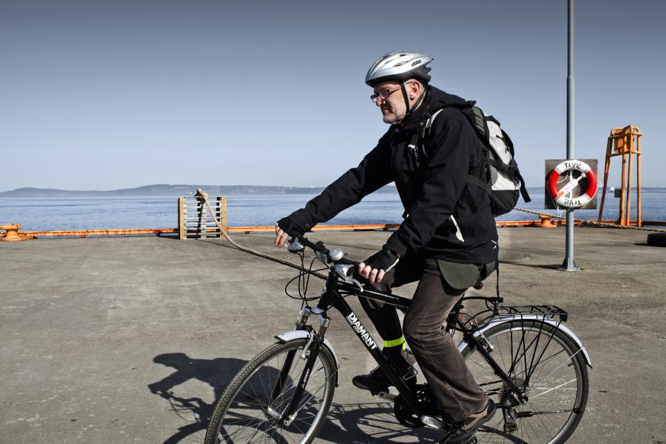 BASTOY ISLAND, HORTEN, NORWAY - APRIL 11:  Arne Kvernvik Nilsen, Governor of the Bastoy Prison is seen on his bycicle as he finish working and he leaves the prison on April 11, 2011 in Bastoy Island, Horten, Norway. Bastoy Prison is a minimum security prison located on Bastoy Island, Norway, about 75 kilometers (46 mi) south of Oslo. The facility is located on a 2.6 square kilometer (1 sq mi) island and hosts 115 inmates. Arne Kvernvik Nilsen, governor of the prison, leads a staff of about 70 prison employees. Of this staff, only five employees remain on the island overnight.  Once a prison colony for young boys, the facility now is trying to become 'the first eco-human prison in the world.' Inmates are housed in wooden cottages and work the prison farm. During their free time, inmates have access to horseback riding, fishing, tennis, and cross-country skiing. (Photo by Marco Di Lauro/Reportage by Getty Images)