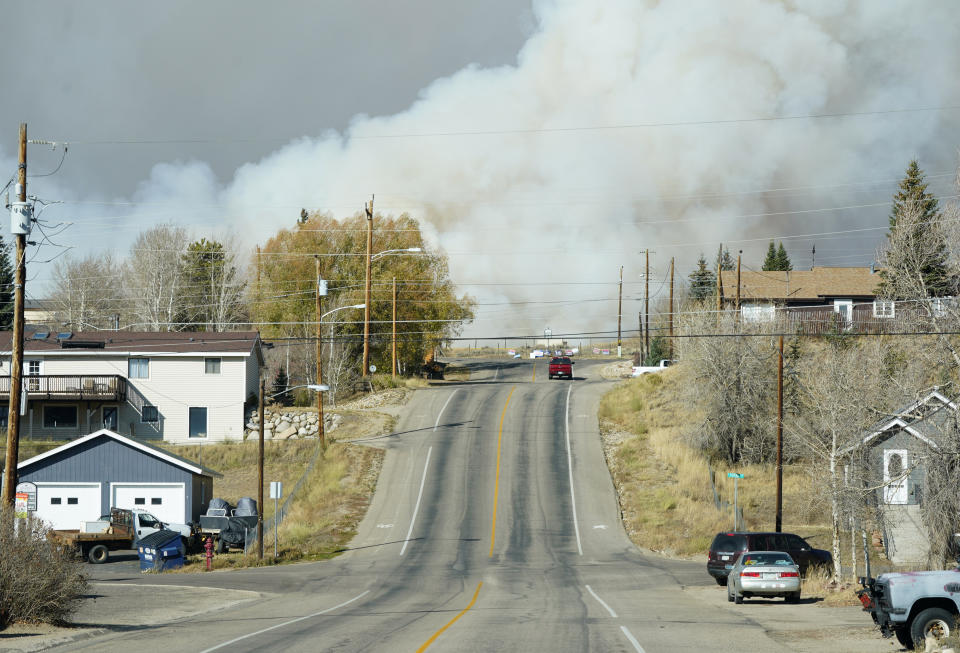 Smoke from wildfires rises in the background near Granby, Colorado.