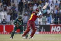 West Indies Nicholas Pooran, right, bats while Pakistan's Mohammad Rizwan watches during the first one day international cricket match between Pakistan and West Indies at the Multan Cricket Stadium, in Multan, Pakistan, Wednesday, June 8, 2022. (AP Photo/Anjum Naveed)