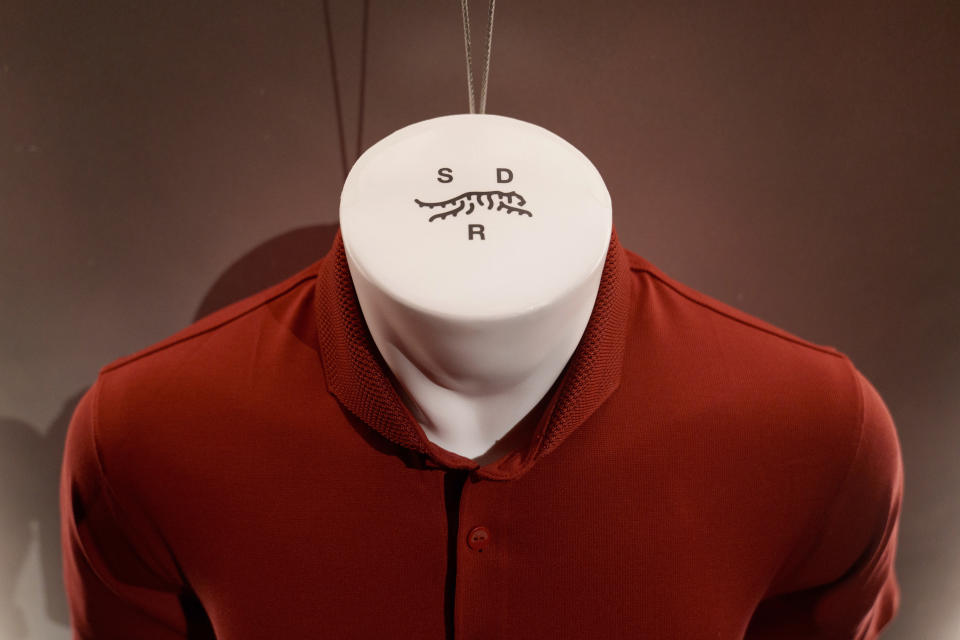 Merchandise from Tiger Woods' new clothing line, called Sun Day Red, is displayed during a news conference ahead of the Genesis Open golf tournament, Monday, Feb. 12, 2024, in the Pacific Palisades area of Los Angeles. (AP Photo/Eric Thayer)