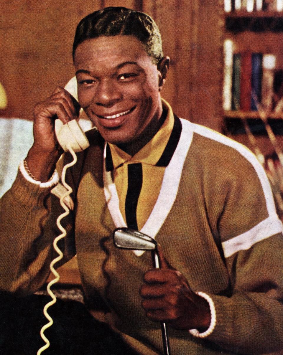 Cole posing for a portrait, pretending to talk on the phone, in the early '60s