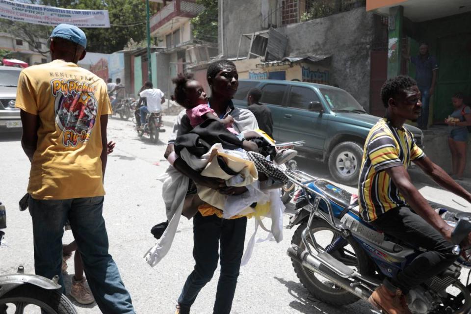 Residents flee their homes to escape clashes between armed gangs in the Carrefour-Feuilles district of Port-au-Prince, Haiti, on Tuesday, Aug. 15, 2023.