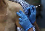 FILE - In this Tuesday, Dec. 8, 2020 file photo a nurse administers the Pfizer-BioNTech COVID-19 vaccine at Guy's Hospital in London as U.K. health authorities rolled out the first doses of a widely tested and independently reviewed COVID-19 vaccine. (AP Photo/Frank Augstein, File)