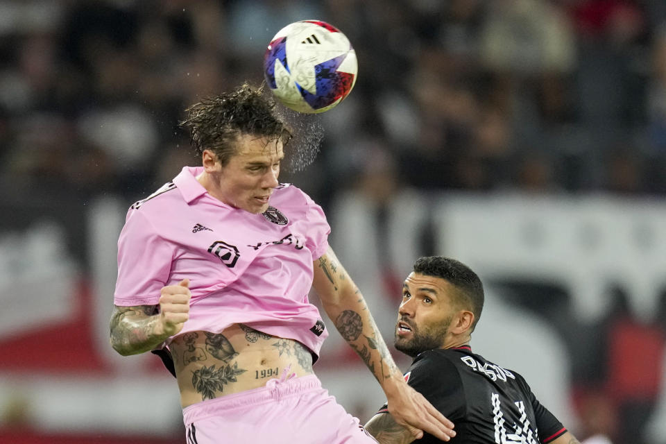 Inter Miami midfielder Robert Taylor, left, heads the ball in front of D.C. United midfielder Victor Pálsson during the second half of an MLS soccer match, Saturday, July 8, 2023, in Washington. (AP Photo/Alex Brandon)