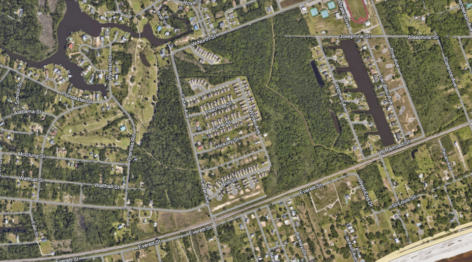 The Pass Estates subdivision includes most of the homes west of Cedar Avenue shown on the center square of this aerial screenshot from Google Earth, including the row of houses off West North Street. Google Earth