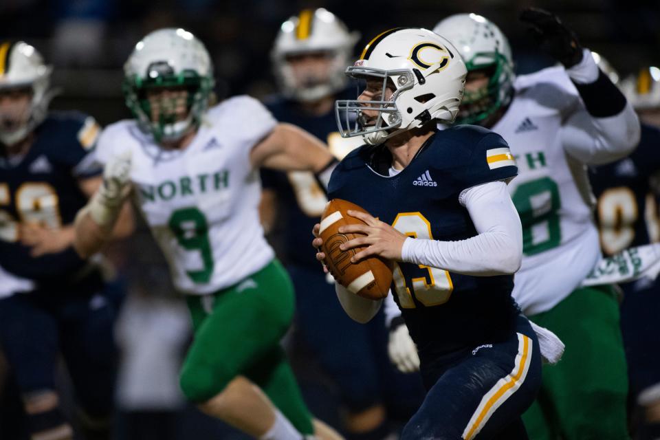 Castle’s Brayden Bishop (13) looks to pass as the Castle Knights play the North Huskies during the IHSAA Class 5A sectional championship game at John Lidy Field in Newburgh, Ind., Friday, Nov. 4, 2022. 