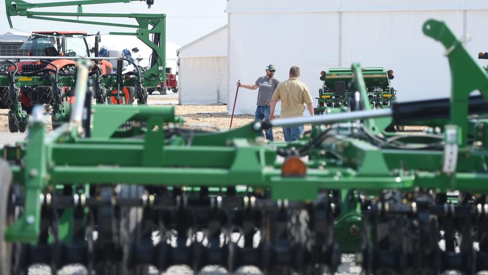 Workers prepare tents and farm equipment for display at the upcoming Farm Progress Show on Wednesday, Aug. 24, 2022, in Boone, Iowa.