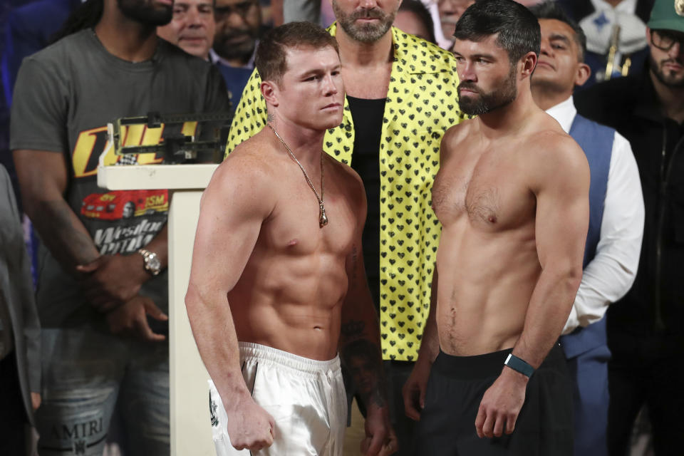 Boxers Saul "Canelo" Alvarez of Mexico, left, and John Ryder of Britain, face each other during their weigh-in ceremony in Guadalajara, Mexico, Friday, May 5, 2023. Alvarez and Ryder will meet for a super middleweight championship fight at Akron Stadium on May 6. (AP Photo/Refugio Ruiz)