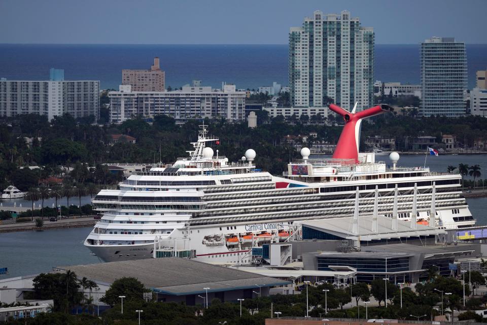 The Carnival Conquest cruise ship sits docked at port on Oct. 20, 2021, in Miami.