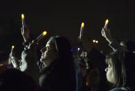 Residents of Staten Island in New York City hold lights and candles as they stand on Midland Beach on the south shore of the Island during a "Light the Shore" event to commemorate the one-year anniversary of Hurricane Sandy in New York October 29, 2013. A year after Superstorm Sandy inundated the East Coast with record flooding that left 159 people dead, residents of hard-hit New Jersey and New York shore communities still have a ways to go in rebuilding damaged homes. REUTERS/Mike Segar (UNITED STATES - Tags: ANNIVERSARY DISASTER ENVIRONMENT)