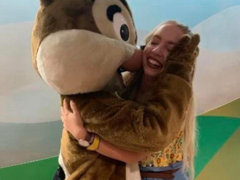 kayleigh posing with chip at garden grill in disney world