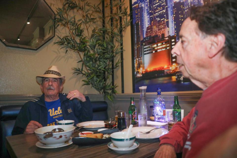 Two people seated at a restaurant table.