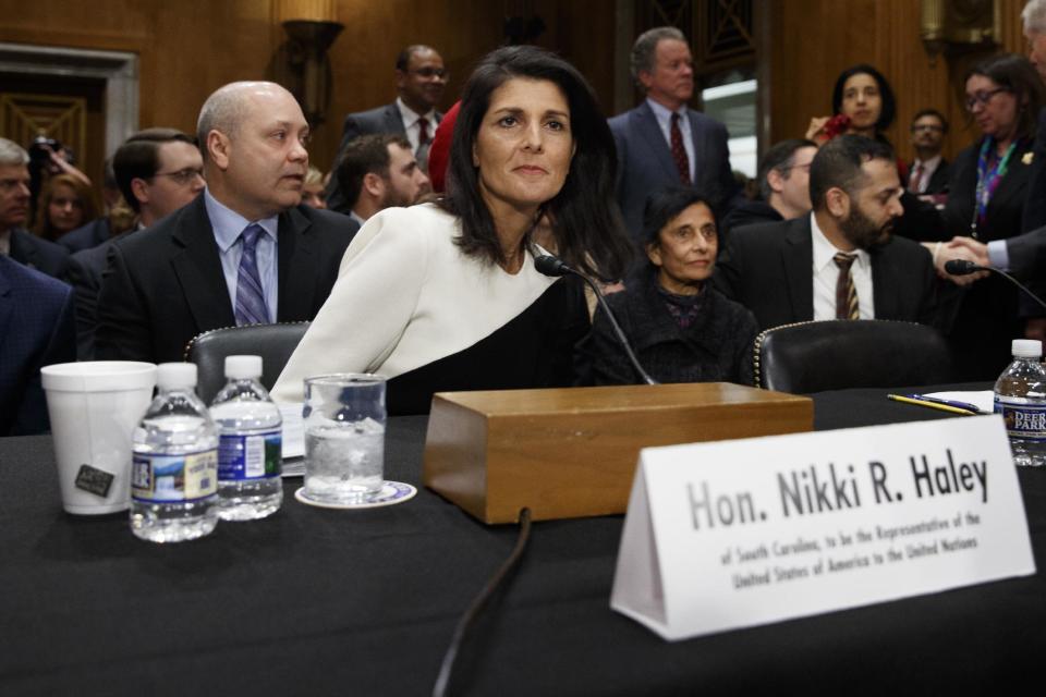 UN Ambassador-designate, South Carolina Gov. Nikki Haley, accompanied by her husband Michael, left, prepares to testify on Capitol Hill in Washington, Wednesday, Jan. 18, 2017, at her confirmation hearing before the Senate Foreign Relations Committee. (AP Photo/Evan Vucci)