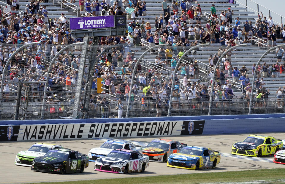 Drivers pass under the green flag to start a NASCAR Xfinity Series auto race Saturday, June 25, 2022, in Lebanon, Tenn. (AP Photo/Mark Humphrey)