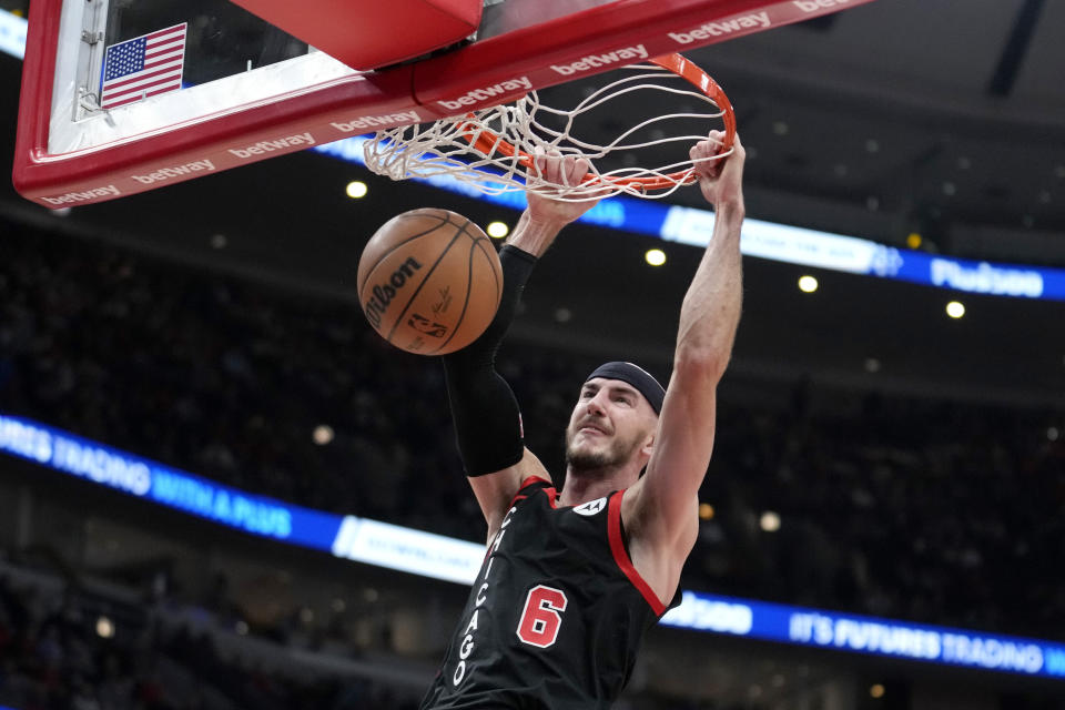 Chicago Bulls' Alex Caruso dunks against the Detroit Pistons during the first half of an NBA basketball game Tuesday, Feb. 27, 2024, in Chicago. (AP Photo/Charles Rex Arbogast)