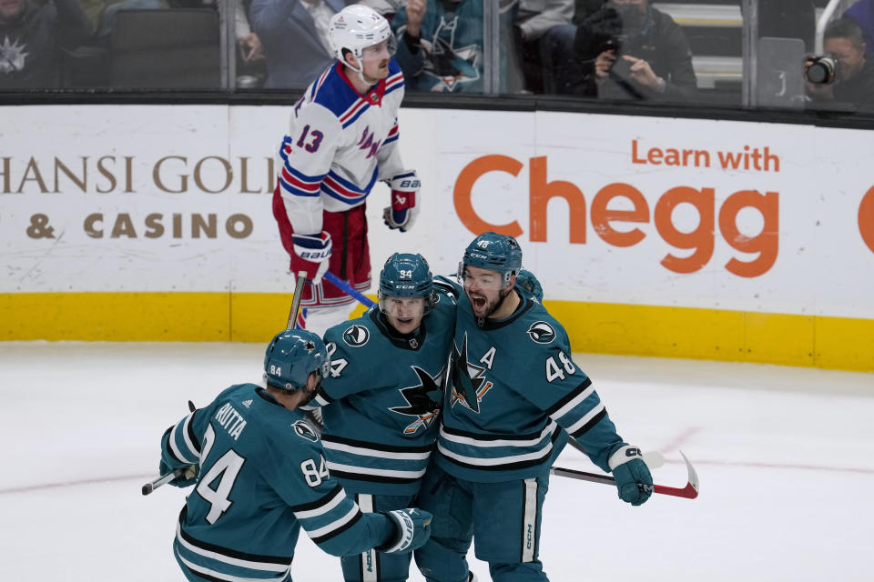 San Jose Sharks center Tomas Hertl, right, celebrates with defenseman Jan Rutta, left, and left wing Alexander Barabanov after scoring against the New York Rangers during overtime in an NHL hockey game Tuesday, Jan. 23, 2024, in San Jose, Calif. (AP Photo/Godofredo A. Vásquez)