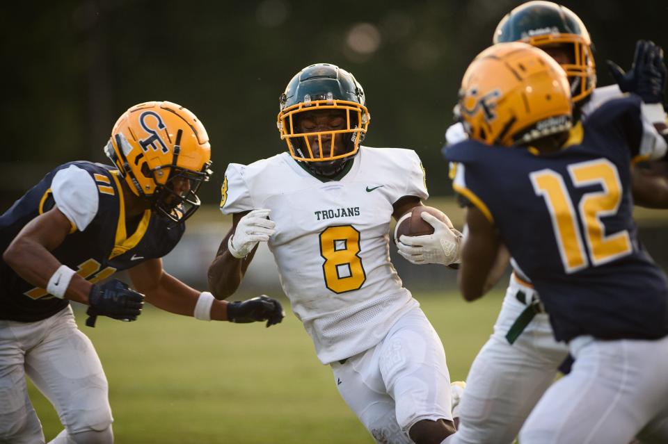 Pine Forest's Fredrick Logan attempts to run past Cape Fear's Arrington Kee during the first quarter on Friday, Aug. 18, 2023, at Cape Fear High School.