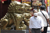 A man wearing a face mask to protect against the spread of the new coronavirus walks through China Town in Yokohama, near Tokyo, Wednesday, June 3, 2020. A coronavirus state of emergency was lifted, ending the restrictions nationwide as businesses began to reopen. (AP Photo/Koji Sasahara)