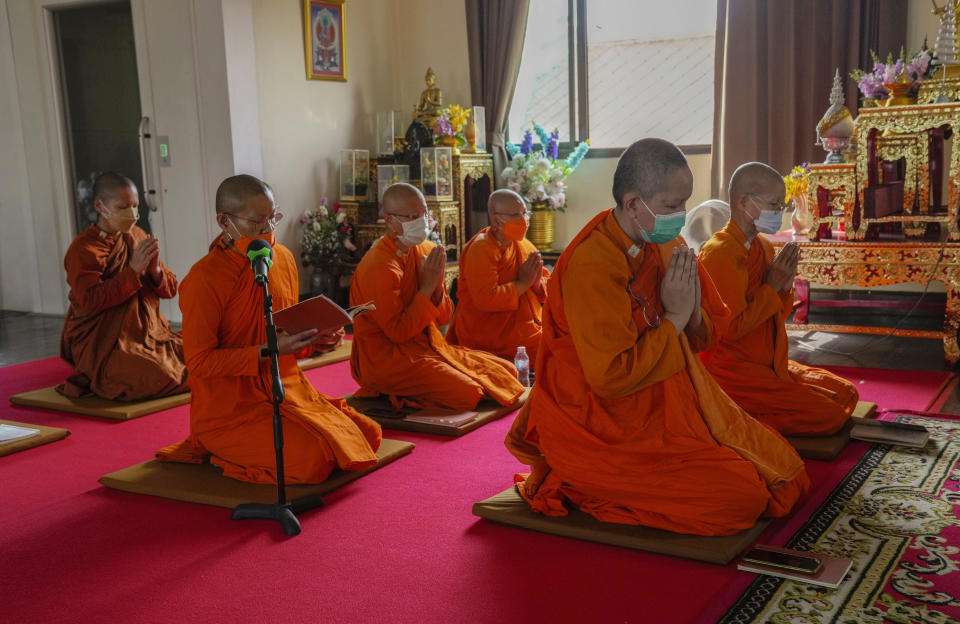 Bhikkhuni pray at Songdhammakalyani monastery in Nakhon Pathom province on Sunday, Nov. 21, 2021. Historically, women could only become white-cloaked nuns often treated as glorified temple housekeepers. But dozens have traveled to Sri Lanka to receive full ordination. (AP Photo/Sakchai Lalit)