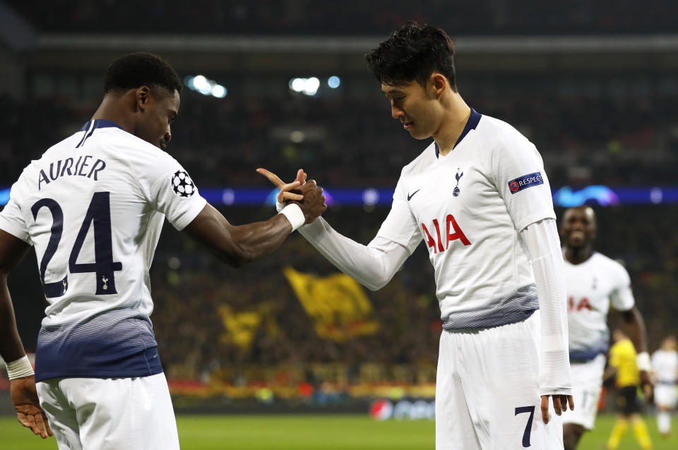 Tottenham midfielder Son Heung-min celebrates with defender Serge Aurier, left, after scoring the opening goal during the Champions League round of 16, first leg, soccer match between Tottenham Hotspur and Borussia Dortmund at Wembley stadium in London, Wednesday, Feb. 13, 2019. (AP Photo/Alastair Grant)