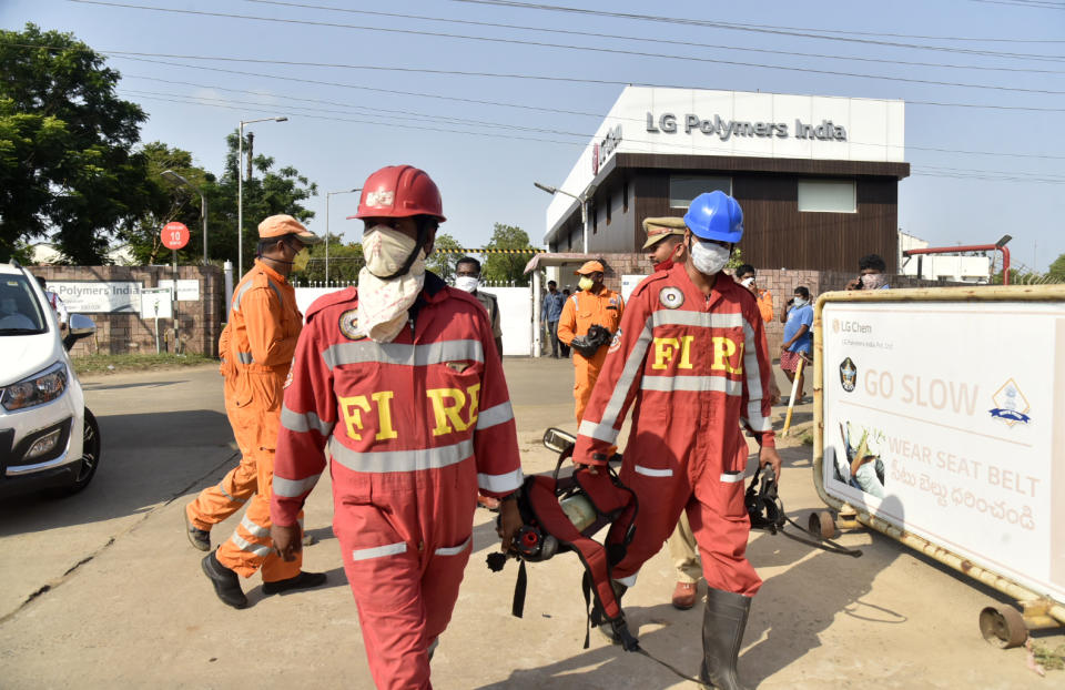 Firefighters walk with oxygen cylinders outside LG Polymers plant, the site of a chemical gas leak, in Vishakhapatnam, India, Thursday, May 7, 2020. Synthetic chemical styrene leaked from the industrial plant in southern India early Thursday, leaving people struggling to breathe and collapsing in the streets as they tried to flee. Administrator Vinay Chand said several people fainted on the road and were rushed to a hospital. (AP Photo)