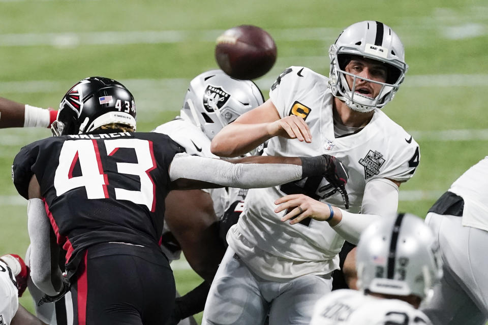 Atlanta Falcons linebacker Mykal Walker (43) hits Las Vegas Raiders quarterback Derek Carr (4) during the second half of an NFL football game, Sunday, Nov. 29, 2020, in Atlanta. Carr through an interception on the play. (AP Photo/John Bazemore)