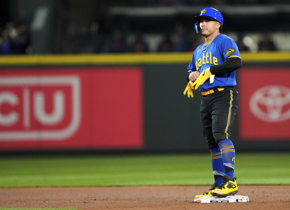 Seattle Mariners' Kolten Wong stands on second base after hitting a three-run double against the Houston Astros during the fifth inning of a baseball game Friday, May 5, 2023, in Seattle. (AP Photo/Lindsey Wasson)