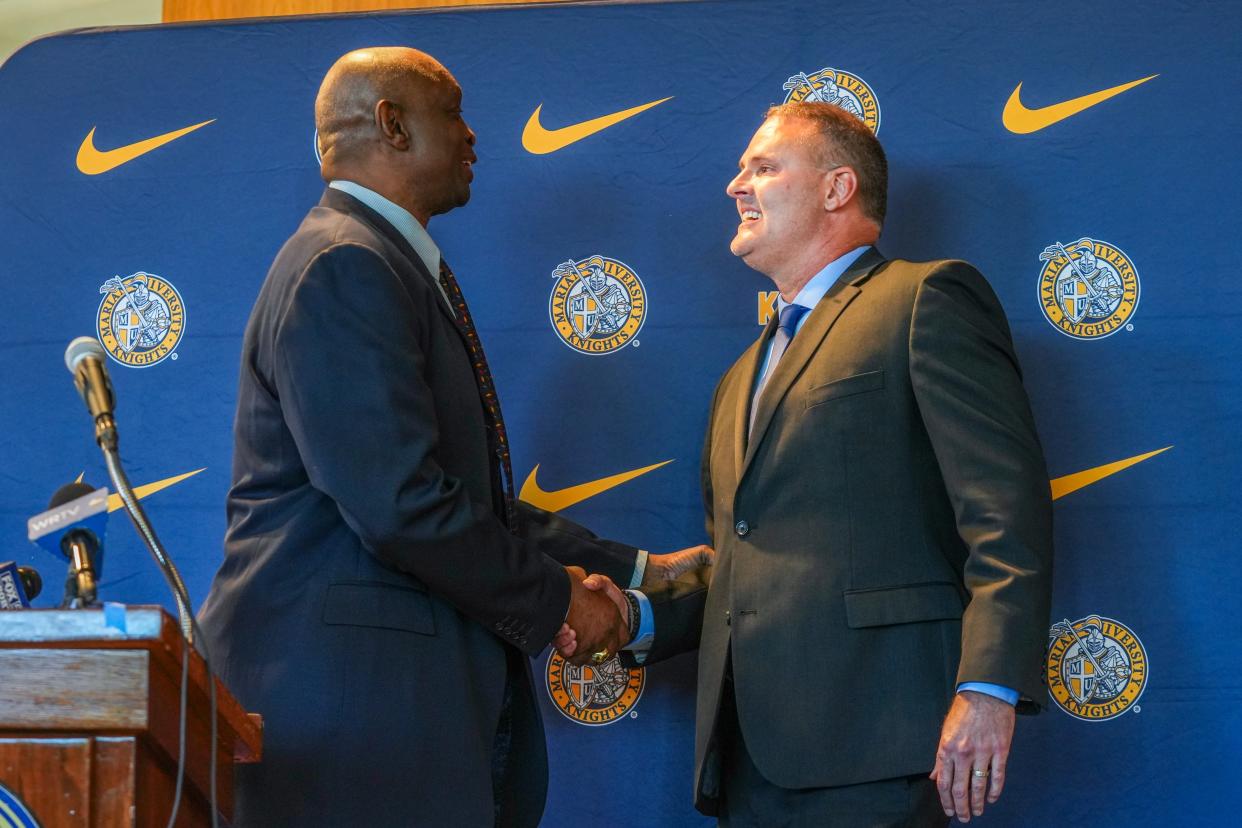 Steve Downing, Marian University director of athletics, shakes hands with Pat Knight, Marian’s new men’s basketball head coach, during a press conference, Friday, May 10, 2024, in the Peyton Manning Children’s Hospital Hall of Champions at Marian University in Indianapolis.
