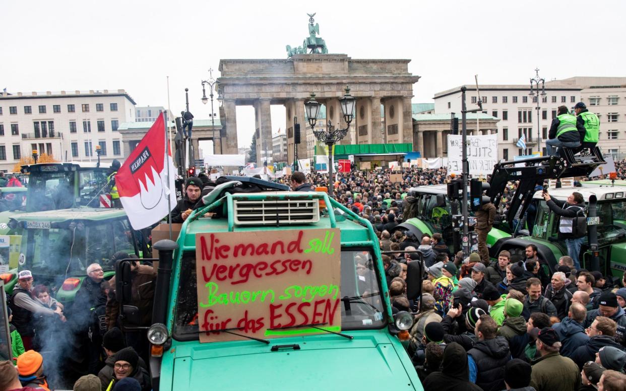 The protest is the latest in a series by farmers, including this in Berlin last month in front of the Brandenburg Gate (the poster reads: 'No-one should forget the farmers make the food').  - DPA