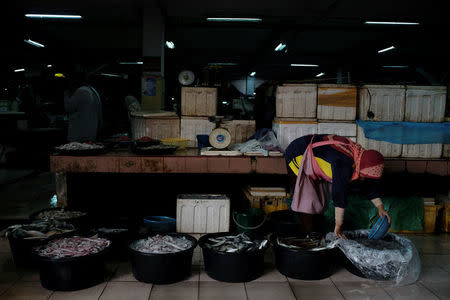 A fishmonger works at her stall at a market in Kota Bharu, Kelantan, Malaysia April 12, 2018. REUTERS/Stringer