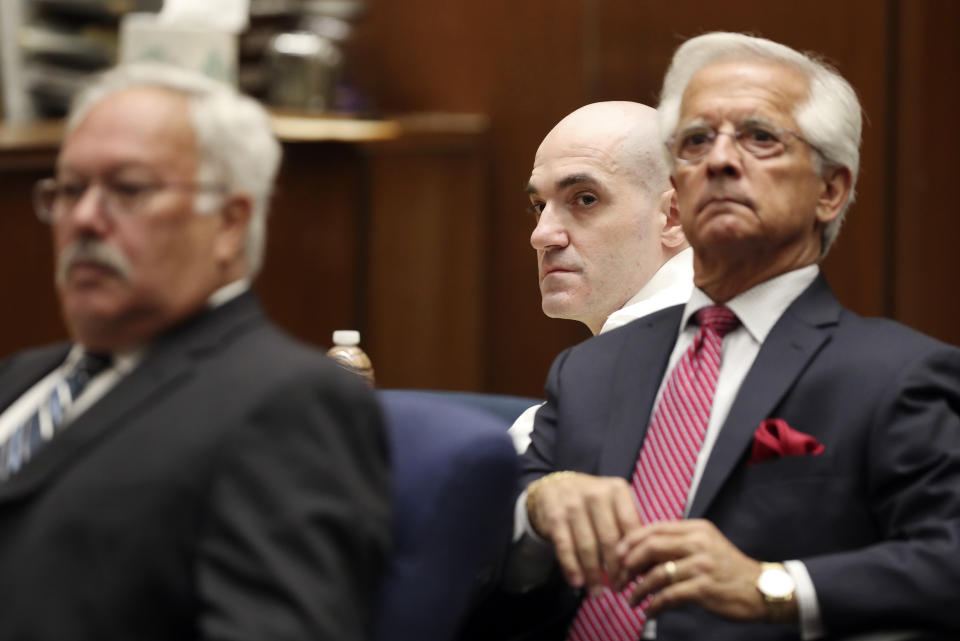 Michael Gargiulo, center, sits in front of his attorneys, Daniel Nardoni, right, and Dale Rubin during a court appearance Tuesday, Aug. 6, 2019, in Los Angeles. Closing arguments started Tuesday in the trial of an air conditioning repairman charged with killing two Southern California women and attempting to kill a third. (Lucy Nicholson, Pool Photo via AP)