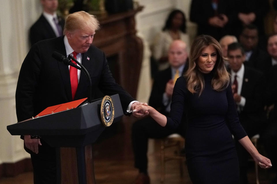 Donald Trump held Melania’s hand following their embrace to escort her down from the microphone. Source: Getty