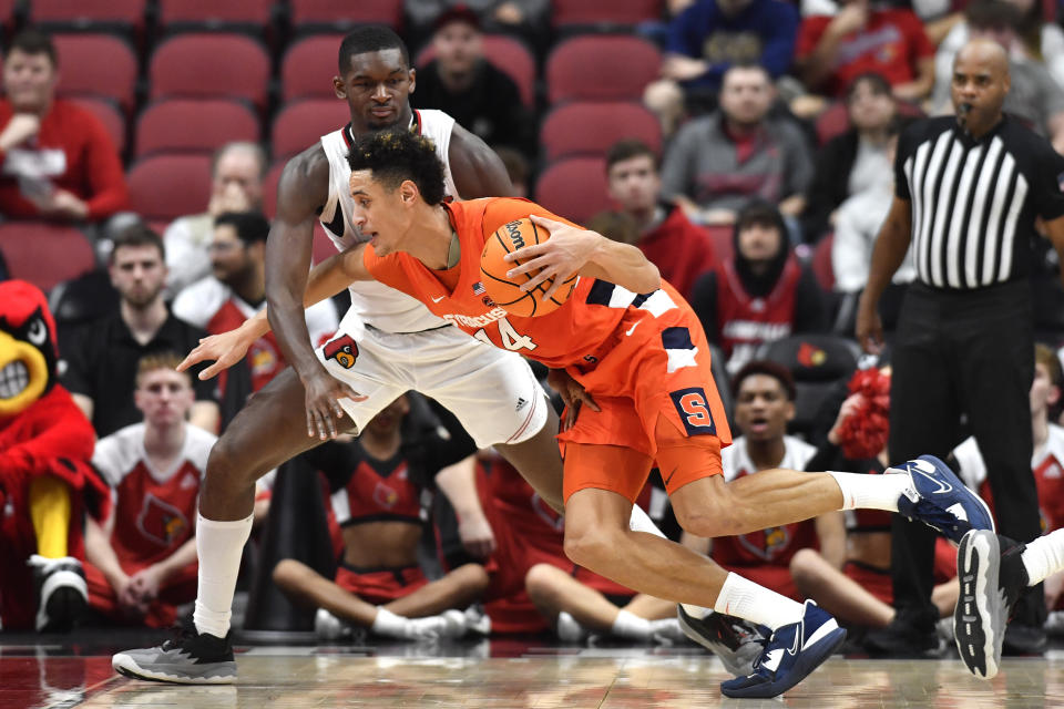 Syracuse center Jesse Edwards (14) tries to drive past Louisville forward Brandon Huntley-Hatfield (5) during the second half of an NCAA college basketball game in Louisville, Ky., Tuesday, Jan. 3, 2023. Syracuse won 70-69. (AP Photo/Timothy D. Easley)