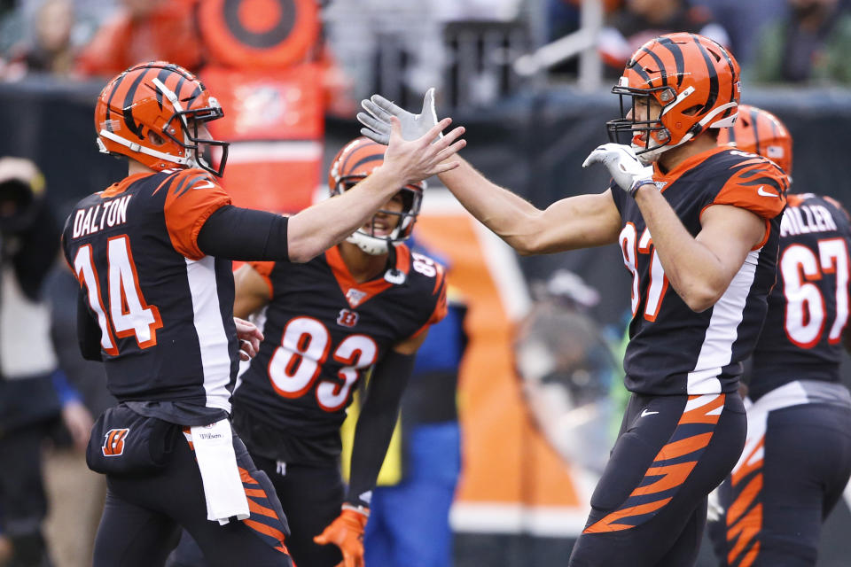 Cincinnati Bengals tight end C.J. Uzomah, right, and quarterback Andy Dalton (14) celebrate after a 15-yard touchdown by Uzomah during the first half of an NFL football game against the Cleveland Browns, Sunday, Dec. 29, 2019, in Cincinnati. (AP Photo/Gary Landers)
