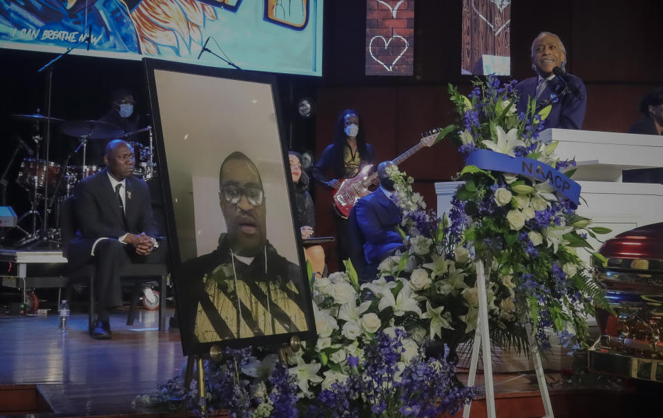 FILE - In this June 4, 2020, file photo, civil rights attorney Ben Crump listens as Rev. Al Sharpton delivers the eulogy at the funeral George Floyd in Minneapolis. For more than three decades, Sharpton, 65, has been a go-to advocate for Black American families seeking justice and peace in the wake of violence and countless incidents that highlight systemic racism. (AP Photo/Bebeto Matthews, File)