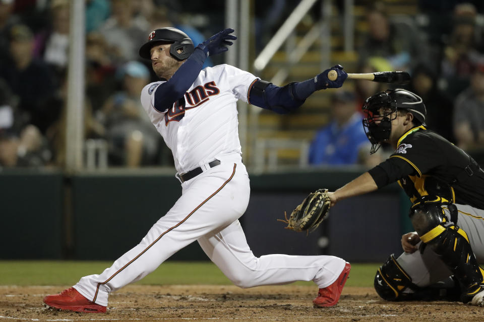 FILE - Minnesota Twins' Josh Donaldson follows through on a double as Pittsburgh Pirates catcher Andrew Susac looks on in the third inning of a spring training baseball game in Fort Myers, Fla., in this Saturday, Feb. 29, 2020, file photo. When Josh Donaldson was on the field in his first season with Minnesota, he produced and contributed the way the Twins planned. The problems were the pandemic-shortened schedule and the nagging calf injury that limited Donaldson to 28 games in 2020. He and the team are banking on a healthier year.(AP Photo/John Bazemore, File)