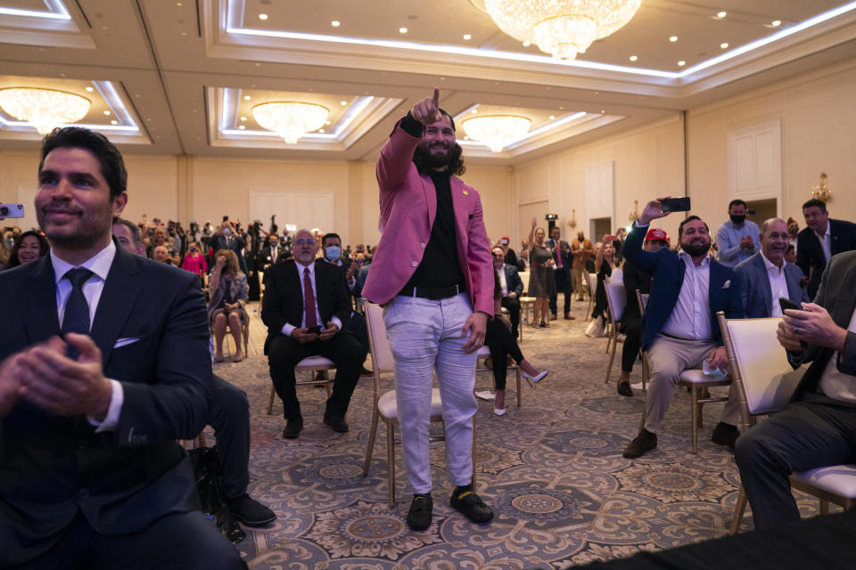 UFC fighter Jorge Masvidal points at President Donald Trump during a Latinos for Trump event at Trump National Doral Miami resort, Friday, Sept. 25, 2020, in Doral, Fla. (AP Photo/Evan Vucci)